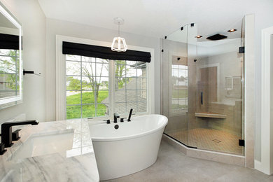 Design ideas for a mid-sized transitional master bathroom in Chicago with grey cabinets, a freestanding tub, a corner shower, gray tile, ceramic tile, grey walls, ceramic floors, an undermount sink, engineered quartz benchtops, grey floor, a hinged shower door, white benchtops, a shower seat, a single vanity and a freestanding vanity.