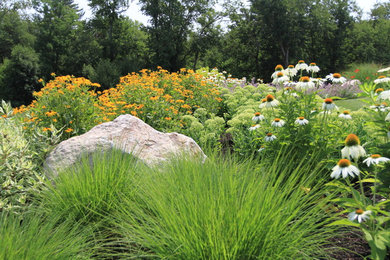 This is an example of a large traditional backyard landscaping in Boston.