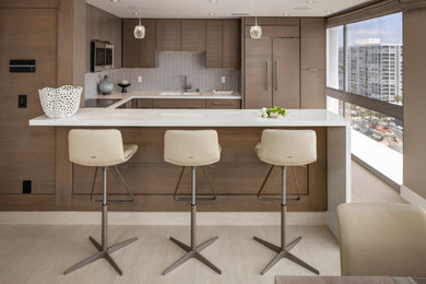 Kitchen - contemporary u-shaped beige floor kitchen idea in San Diego with flat-panel cabinets, medium tone wood cabinets, blue backsplash and white countertops