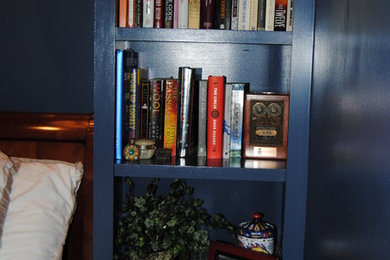 Example of a transitional master medium tone wood floor bedroom design in Boston with blue walls