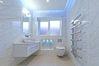 Inspiration for a small modern bathroom in Devon with a wall mounted toilet, white tiles, porcelain tiles, white walls, porcelain flooring, a wall-mounted sink, marble worktops, grey floors, an open shower, white worktops, a wall niche and a drop ceiling.