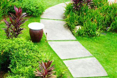 Photo of a mid-sized full sun front yard concrete paver garden path in Vancouver.