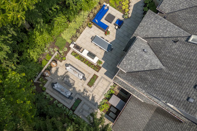 Patio kitchen - large transitional backyard concrete paver patio kitchen idea in Toronto with no cover