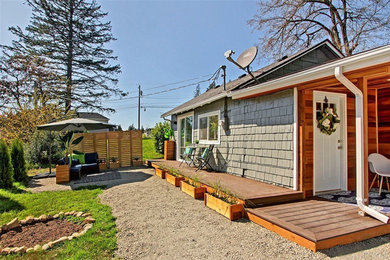 Small transitional green one-story wood house exterior idea in Seattle with a hip roof and a shingle roof