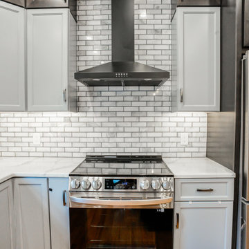 Multi-Tone Grey Cabinets w/ Island & Hardwood Floors