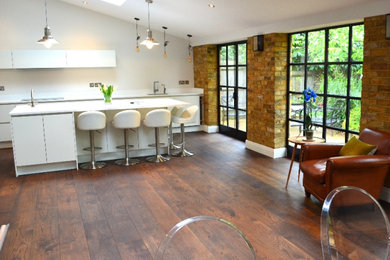 Large modern living room in Surrey with medium hardwood flooring.