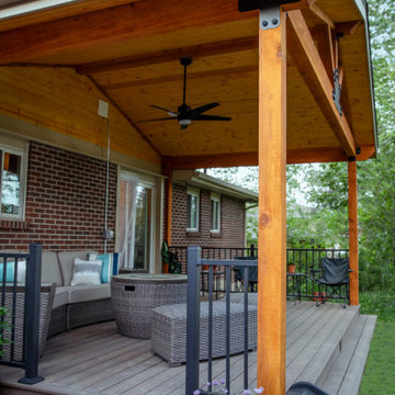 Boulder Patio Cover with Deckorators Decking and Railing and Stamped Concrete