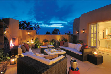 Inspiration for a side yard patio in Albuquerque with a fire feature and natural stone pavers.