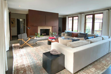 Example of a mid-sized 1960s open concept dark wood floor living room design in San Francisco with white walls, a standard fireplace, a stone fireplace and a media wall