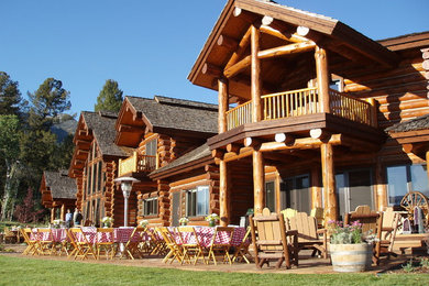 Huge rustic brown two-story wood exterior home idea in Other