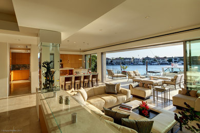Inspiration for a large contemporary open concept marble floor and beige floor living room remodel in Orange County with beige walls