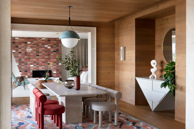 Example of a mid-century modern medium tone wood floor, brown floor, wood wall and wood ceiling enclosed dining room design in Vancouver with brown walls