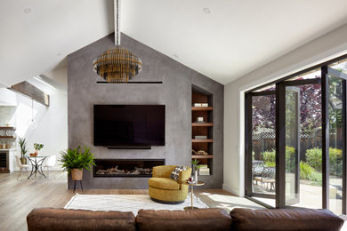 Inspiration for a large formal and open concept light wood floor, brown floor and vaulted ceiling living room remodel in San Francisco with beige walls, a ribbon fireplace, a plaster fireplace and a wall-mounted tv