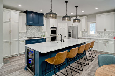 Eat-in kitchen - eclectic l-shaped vinyl floor and gray floor eat-in kitchen idea in Minneapolis with a farmhouse sink, shaker cabinets, white cabinets, quartz countertops, gray backsplash, marble backsplash, stainless steel appliances, an island and white countertops