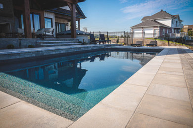 Inspiration for a mid-sized scandinavian backyard brick and rectangular pool remodel