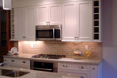 This is an example of a transitional galley eat-in kitchen in Toronto.