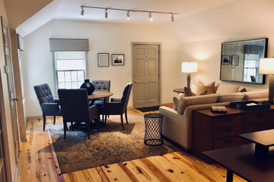 Huge transitional freestanding desk light wood floor home studio photo in New York with white walls