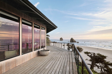 Inspiration for a mid-sized coastal metal railing balcony remodel in Portland with a fire pit and no cover
