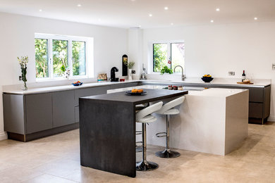 Photo of a large contemporary l-shaped kitchen in Other with flat-panel cabinets, grey cabinets, quartzite benchtops, white splashback, porcelain floors, with island, beige floor and white benchtop.