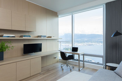 Example of a trendy built-in desk light wood floor study room design in Vancouver