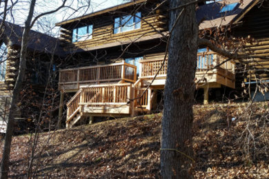 Inspiration for a large rustic beige two-story wood exterior home remodel in Other with a shingle roof