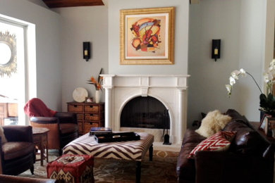 Elegant porcelain tile living room photo in Miami with blue walls, a standard fireplace and a stone fireplace