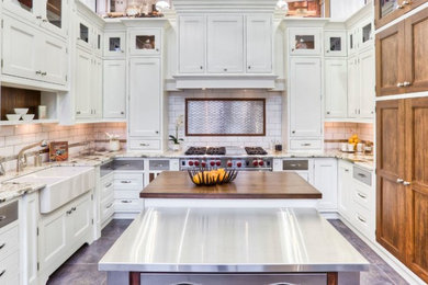 Inspiration for a large transitional u-shaped porcelain tile eat-in kitchen remodel in Toronto with a farmhouse sink, beaded inset cabinets, white cabinets, granite countertops, white backsplash, subway tile backsplash, stainless steel appliances and an island