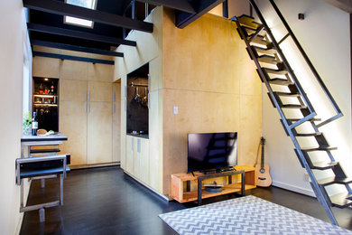 Small trendy loft-style plywood floor living room photo in Portland with a tv stand