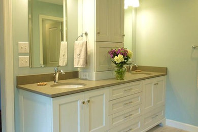 Mid-sized master ceramic tile bathroom photo in Other with a drop-in sink, recessed-panel cabinets, white cabinets, solid surface countertops and blue walls