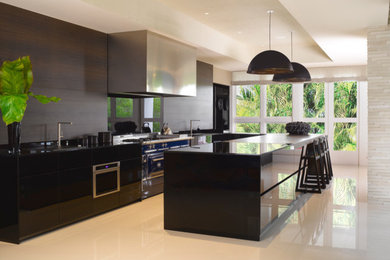 Photo of a mid-sized modern u-shaped eat-in kitchen in Miami with an undermount sink, flat-panel cabinets, black cabinets, quartzite benchtops, black splashback, timber splashback, stainless steel appliances, porcelain floors, with island, white floor and black benchtop.