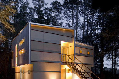 Mid-sized modern beige two-story mixed siding house exterior idea in Jacksonville with a shed roof