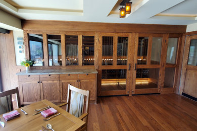 Example of an arts and crafts dark wood floor wine cellar design in Phoenix