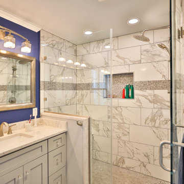 Master bathroom remodel in Groveton with corner bathtub & marble lined tiles