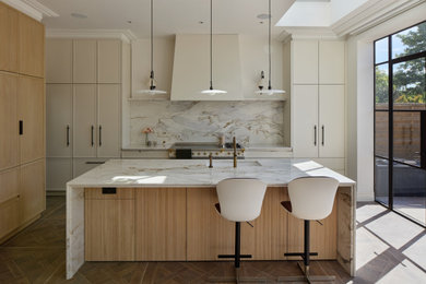 Inspiration for a large contemporary l-shaped utility room in London with recessed-panel cabinets.