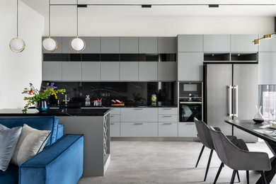Photo of a large contemporary kitchen in Moscow with laminate floors and grey floor.