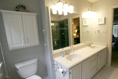 Example of a transitional master gray tile and stone tile porcelain tile bathroom design in Raleigh with gray walls, an integrated sink and marble countertops