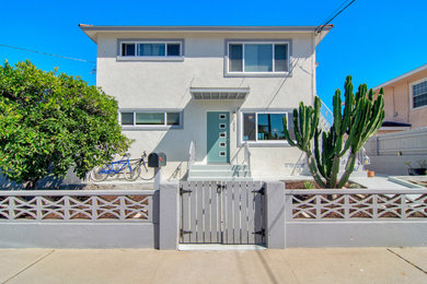 Mid-sized contemporary white two-story stucco exterior home idea in San Diego with a shingle roof