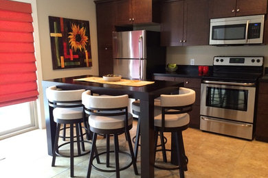 Inspiration for a small contemporary l-shaped ceramic tile enclosed kitchen remodel in Other with a double-bowl sink, recessed-panel cabinets, dark wood cabinets and stainless steel appliances