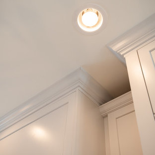 Inspiration for a mid-sized eclectic galley kitchen pantry in Denver with an undermount sink, shaker cabinets, turquoise cabinets, quartz benchtops, grey splashback, ceramic splashback, stainless steel appliances, light hardwood floors, with island, brown floor and white benchtop.