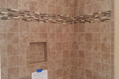 Inspiration for a mid-sized timeless master beige tile and porcelain tile bathroom remodel in Other
