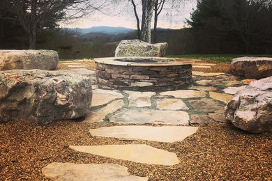 Mid-sized elegant backyard stone patio photo in Charlotte with a fire pit and no cover