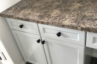 Example of a small transitional built-in desk carpeted and brown floor home office design in Edmonton with white walls