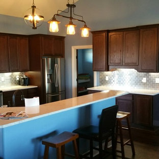 Small traditional kitchen pantry ideas - Small elegant galley dark wood floor kitchen pantry photo in Wichita with metal backsplash, metallic backsplash, quartz countertops, stainless steel appliances, dark wood cabinets, recessed-panel cabinets and an island