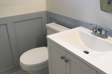 Inspiration for a mid-sized contemporary master gray tile and marble tile marble floor and gray floor bathroom remodel in Ottawa with shaker cabinets, white cabinets, a one-piece toilet, beige walls, an integrated sink and solid surface countertops