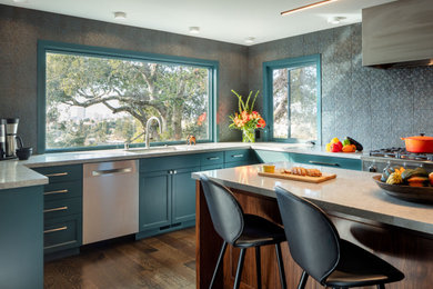 Kitchen - huge transitional u-shaped dark wood floor kitchen idea in San Francisco with an undermount sink, shaker cabinets, blue cabinets, solid surface countertops, blue backsplash, ceramic backsplash, stainless steel appliances, an island and gray countertops