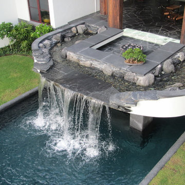 Pool waterfalls and black slate, lava rock stream bed water feature Manalapan, F
