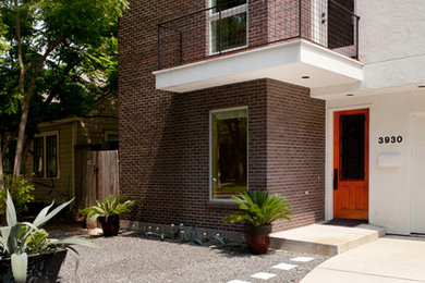 Mid-sized medium tone wood floor entryway photo in Houston with white walls and a red front door