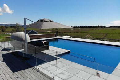 This is an example of a modern swimming pool in Other.
