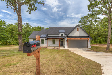 Example of a mid-sized country white one-story mixed siding exterior home design in Other with a mixed material roof