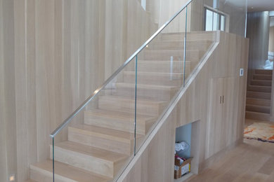 Inspiration for a contemporary wood u-shaped staircase in Los Angeles with wood risers.